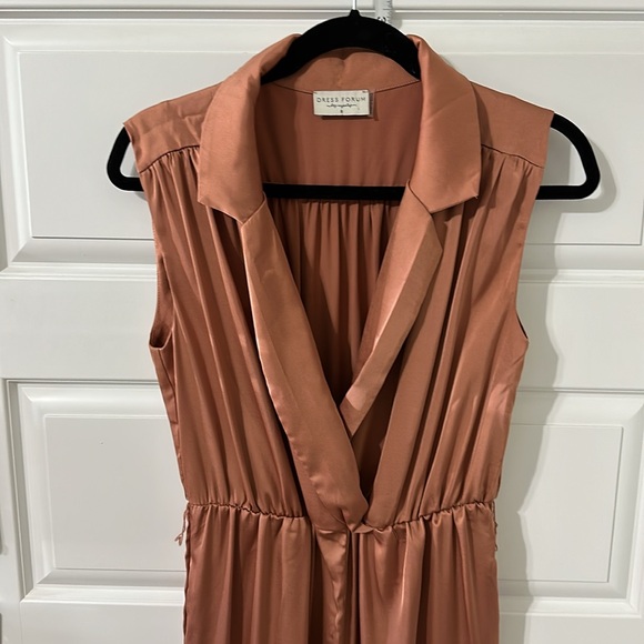 This silky romper is super cute. I am 5’5” & 135 lbs. it’s a salmon/ginger color - Picture 6 of 7